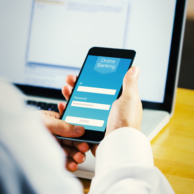 Businessman using smartphone against online banking